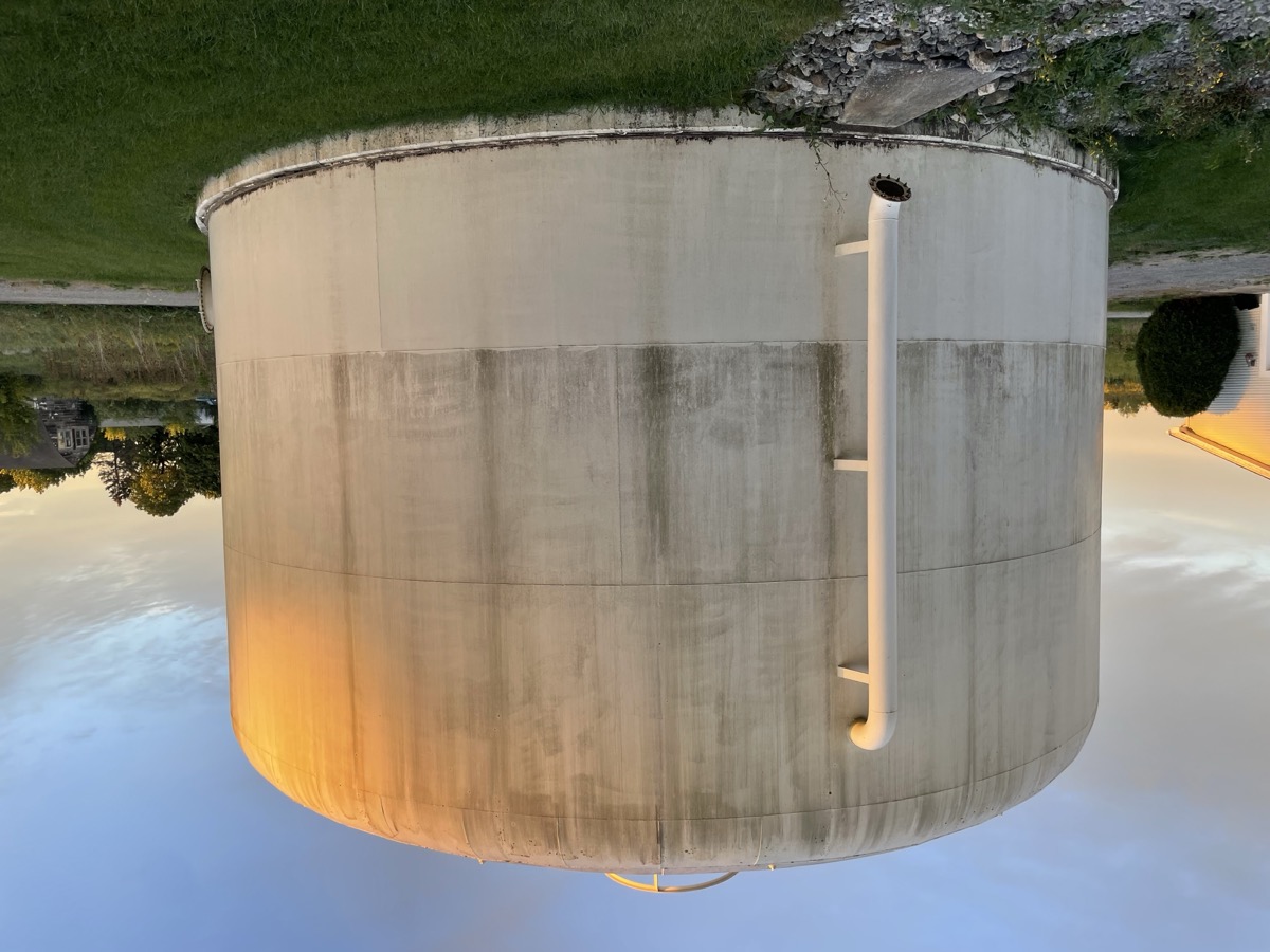 Water tank power washing before