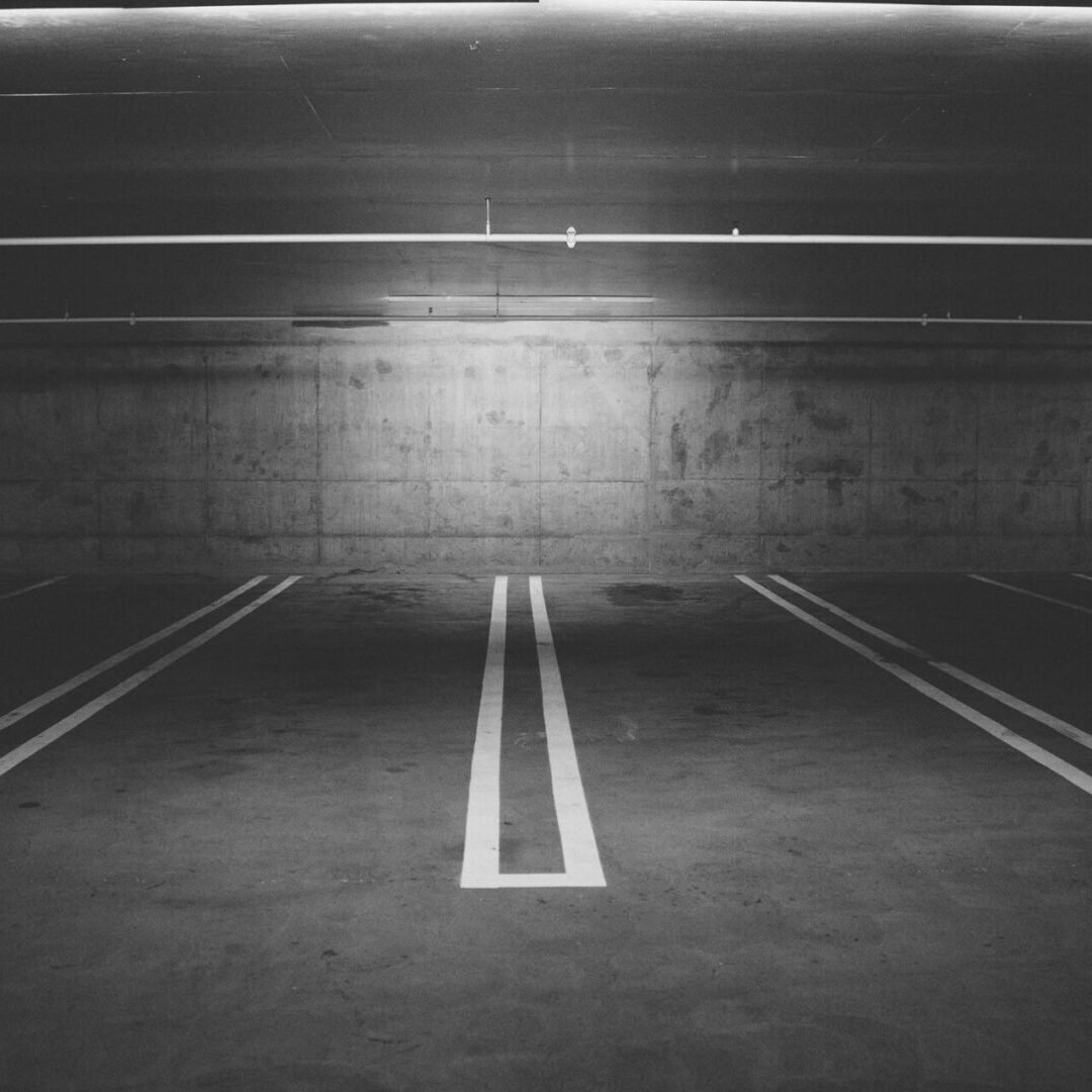 A parking lot with two lines painted on the ground.